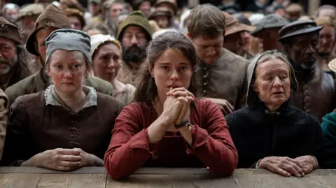 Universal A still from Hamnet showing Jessie Buckley's character at the front of a theatre crowd