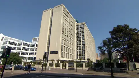 A concrete office block rises from the streets in Bournemouth. The late 20th Century building rises to around nine storeys.