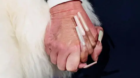 Reuters U.S. President Donald Trump and musician Nicki Minaj hold hands onstage at the U.S. Treasury Department's Trump Accounts Summit, in Washington, D.C., U.S. January 28, 2026. REUTERS/Kevin Lamarque TPX IMAGES OF THE DAY
