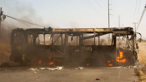 Reuters A bus used as a roadblock by organized crime burns following a federal operation in which a government source said Mexican drug lord Nemesio Oseguera, commonly known as "El Mencho," was killed, in Zapopan, Mexico, February 22, 2026. 